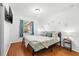 Bright bedroom featuring a window, laminate wood floors, and modern decor at 1242 Whisper Dr, Largo, FL 33770