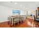 Bright dining room with wood floors, large dining table, and beach-themed artwork at 1242 Whisper Dr, Largo, FL 33770