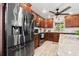 Stainless steel refrigerator and oven with dark wood cabinetry in this renovated kitchen at 1242 Whisper Dr, Largo, FL 33770