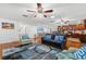 Open-concept living space with hardwood floors, ceiling fans, and comfortable seating, flowing into the kitchen at 1242 Whisper Dr, Largo, FL 33770