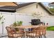 Outdoor patio showcasing a grill, dining set, and putting green at 1242 Whisper Dr, Largo, FL 33770