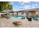 Beautiful pool area complete with lounge chairs, fire pit, outdoor games and mature trees at 1242 Whisper Dr, Largo, FL 33770