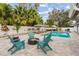 Outdoor pool area featuring a fire pit, comfortable seating, and stylish backyard design at 1242 Whisper Dr, Largo, FL 33770