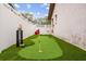 Backyard putting green with artificial turf and golf accessories at 1242 Whisper Dr, Largo, FL 33770