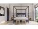Bedroom featuring a four-poster bed, ample natural light, and neutral decor at 125 Avonwood, Tampa, FL 33625