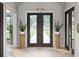 Grand entryway featuring a tiled floor, double doors, and decorative columns at 125 Avonwood, Tampa, FL 33625