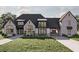 Beautiful home boasts stone accents, an attached garage, and professionally landscaped front yard at 125 Avonwood, Tampa, FL 33625