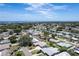 Scenic aerial view displaying the neighborhood homes surrounded by lush greenery under a bright blue sky at 13883 Jamaica Dr, Seminole, FL 33776