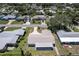 Aerial view showing the roof of the house, driveway, screen porch, and neighborhood at 13883 Jamaica Dr, Seminole, FL 33776