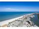 Amazing aerial view of the property, highlighting the proximity to the coastline, waterfront buildings, and sandy beach at 13883 Jamaica Dr, Seminole, FL 33776