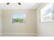 Sunlit bedroom featuring two large windows offering refreshing outdoor views, creating a calm ambiance at 13883 Jamaica Dr, Seminole, FL 33776