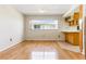 Dining area with wood floors, bright windows, and adjacent kitchen counter at 13883 Jamaica Dr, Seminole, FL 33776