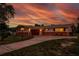 Beautiful home at sunset with a brick exterior, attached garage, and manicured landscaping at 13883 Jamaica Dr, Seminole, FL 33776
