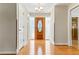 Bright foyer with a decorative front door, hardwood flooring, and a modern chandelier at 13883 Jamaica Dr, Seminole, FL 33776
