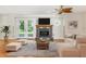 Cozy living room with hardwood floors, a decorative fireplace, and French doors to the backyard at 13883 Jamaica Dr, Seminole, FL 33776