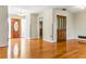 Bright living room showcasing hardwood floors, access to the foyer, and neutral walls at 13883 Jamaica Dr, Seminole, FL 33776