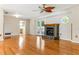 Open-concept living room with hardwood floors, a marble fireplace and French doors at 13883 Jamaica Dr, Seminole, FL 33776