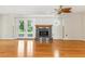Bright living room featuring hardwood floors, a marble fireplace and French doors at 13883 Jamaica Dr, Seminole, FL 33776