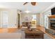 Inviting living room featuring hardwood floors, a decorative fireplace, and a dining area at 13883 Jamaica Dr, Seminole, FL 33776