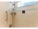Close-up of a renovated shower with a multiple-setting shower head and niche, set against neutral tile at 13883 Jamaica Dr, Seminole, FL 33776