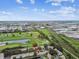 Panoramic aerial view showcasing a townhouse by a serene lake and golf course views at 1508 Adams E Cir, Largo, FL 33771
