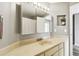 A partial view of a bathroom featuring a large vanity and medicine cabinet at 1508 Adams E Cir, Largo, FL 33771