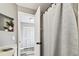 A partial view of the bathroom features a shower and entrance to another room at 1508 Adams E Cir, Largo, FL 33771