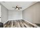 A neutral colored bedroom with wood-look floors and a ceiling fan at 1508 Adams E Cir, Largo, FL 33771
