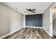 Spacious bedroom features wood-look floors, ceiling fan, and a modern accent wall at 1508 Adams E Cir, Largo, FL 33771