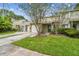 Inviting townhouse featuring lush green grass and mature landscaping, enhancing curb appeal at 1508 Adams E Cir, Largo, FL 33771