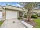 Attractive townhouse with an attached garage, well-maintained lawn, and inviting front entrance at 1508 Adams E Cir, Largo, FL 33771