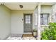 Charming front entry featuring a decorative door, accent window, and 