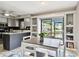 Eat in kitchen includes a dining table, open storage, gray cabinets and a pond view at 1508 Adams E Cir, Largo, FL 33771