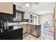 Bright kitchen includes stainless appliances, quartz counters, and white tile floors at 1508 Adams E Cir, Largo, FL 33771