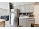This kitchen features stainless steel appliances, granite countertops and white cabinetry at 1508 Adams E Cir, Largo, FL 33771