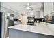 This updated kitchen features new stainless appliances, quartz counters and gray cabinets at 1508 Adams E Cir, Largo, FL 33771