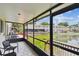An inviting screened porch providing an amazing view of the lily pad covered pond at 1508 Adams E Cir, Largo, FL 33771