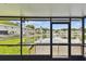 Relaxing screened porch featuring a scenic waterfront view of the lily pad filled lake at 1508 Adams E Cir, Largo, FL 33771