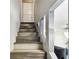 The staircase leads to the upper floor with a modern design at 1508 Adams E Cir, Largo, FL 33771