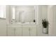 Well-lit bathroom featuring double vanity with marble countertop, neutral cabinets, and modern fixtures at 1554 Serenity Outlook Ct, Lutz, FL 33548