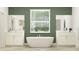 A relaxing bathroom featuring a soaking tub, and dual vanities with marble countertops at 1554 Serenity Outlook Ct, Lutz, FL 33548