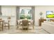 Open dining area featuring lots of natural light, a modern table, and a view into the living room at 1554 Serenity Outlook Ct, Lutz, FL 33548