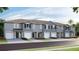 Charming townhomes featuring attached garages and beautifully landscaped front yards at 17465 Spanish Oak Loop, Land O Lakes, FL 34638