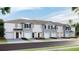 Charming townhomes featuring attached garages and beautifully landscaped front yards at 17465 Spanish Oak Loop, Land O Lakes, FL 34638