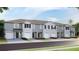 Charming townhomes featuring attached garages and beautifully landscaped front yards at 17465 Spanish Oak Loop, Land O Lakes, FL 34638