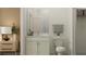 Bathroom with white cabinetry, marble countertops, decorative plant accents, and a modern mirror at 18137 Serene Lake Loop, Lutz, FL 33548