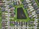 Aerial view of the neighborhood showcasing a central pond with surrounding homes and streets at 1821 Hawks View Dr, Ruskin, FL 33570
