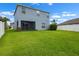 Spacious backyard with lush green lawn and screened in patio at 1821 Hawks View Dr, Ruskin, FL 33570