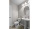 Elegant half bathroom features a pedestal sink and modern fixtures at 1821 Hawks View Dr, Ruskin, FL 33570