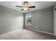 Neutral bedroom featuring plush carpeting and a ceiling fan for added comfort at 1821 Hawks View Dr, Ruskin, FL 33570